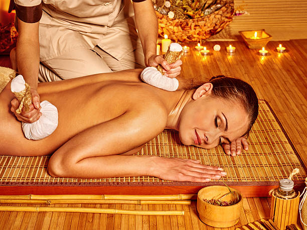 istock Woman getting herbal ball massage 471161830