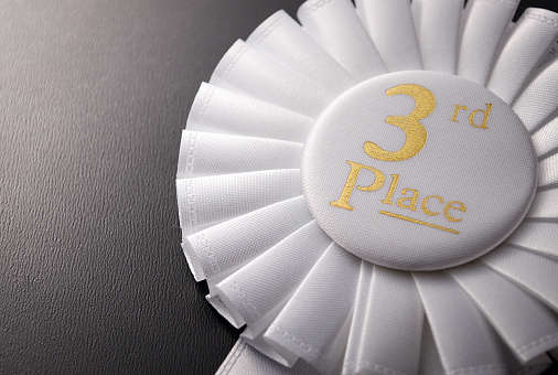3rd place circular white winner rosette a pleated ribbon