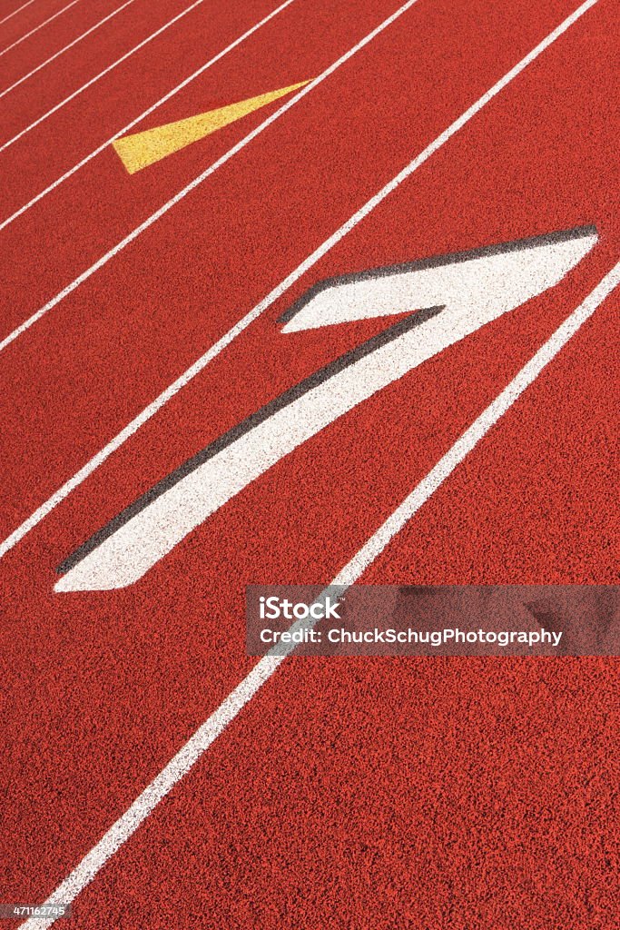 Running Track Sports Training Venue Number seven running lane on diagonally cropped red track and field stadium surface. Starting Gate Stock Photo