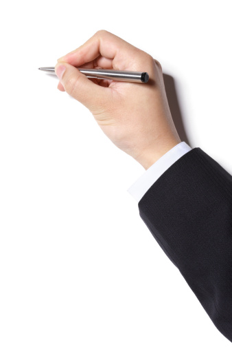 A hand of a businessman writing with a ball-point pen, isolated on white background.