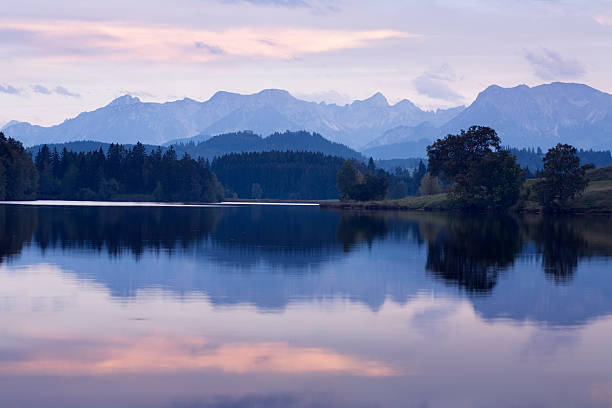 mountain lake at sunset stock photo