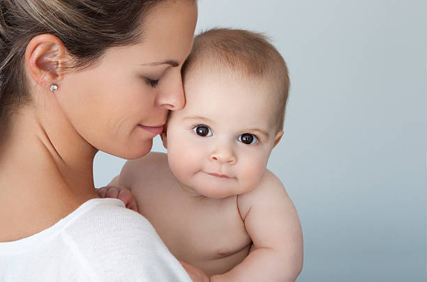 Close-up Of A Mother Loving Her Baby Boy stock photo
