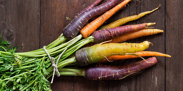 istock Fresh organic rainbow carrots with green 471165230