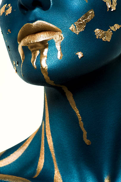 istock Blue beauty Model with liquid Gold on Face. 471165530