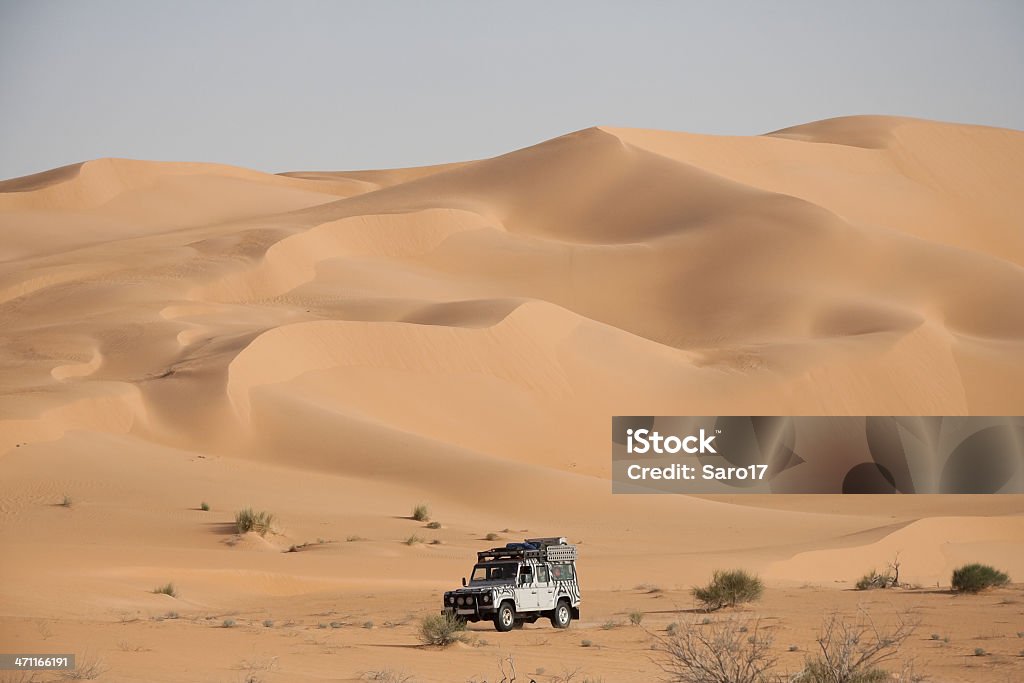 Huge dune, Sahara In the Grand Erg Oriental  - the second largest sand area of the Sahara - the dunes grow up to 200-300m. It´s impossible to cross these dunes by car so you have to bypass them. Before sunset the sand begins to glow golden. 4x4 Stock Photo