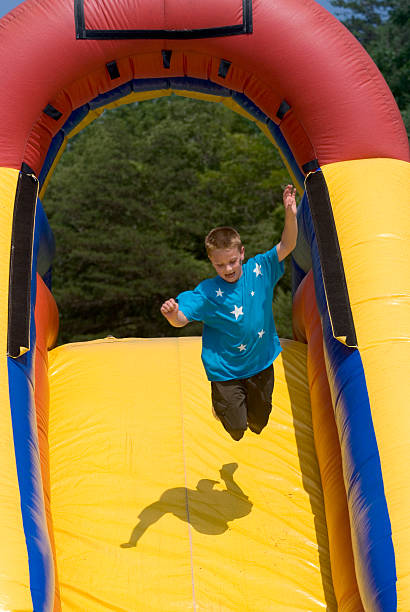 istock Boy Jumping On An Inflatable Slide Midair. 471167373