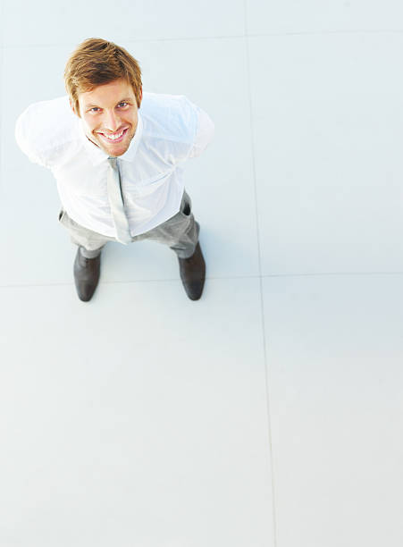 istock Businessman looking upward and smiling 471168105