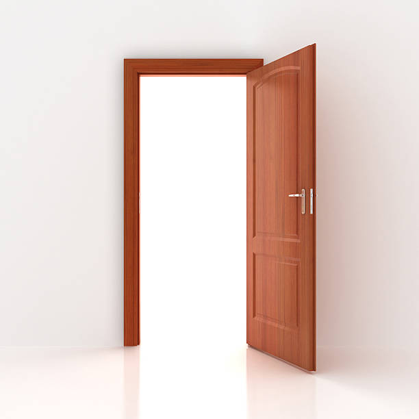 A open wooden door and white walls stock photo