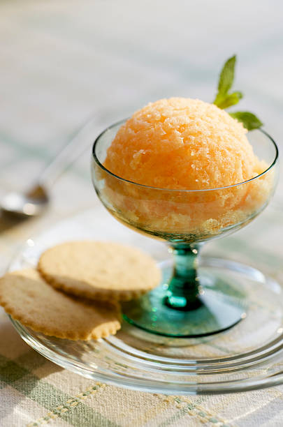 Orange Peach Sorbet in Dessert Bowl with Cookies stock photo