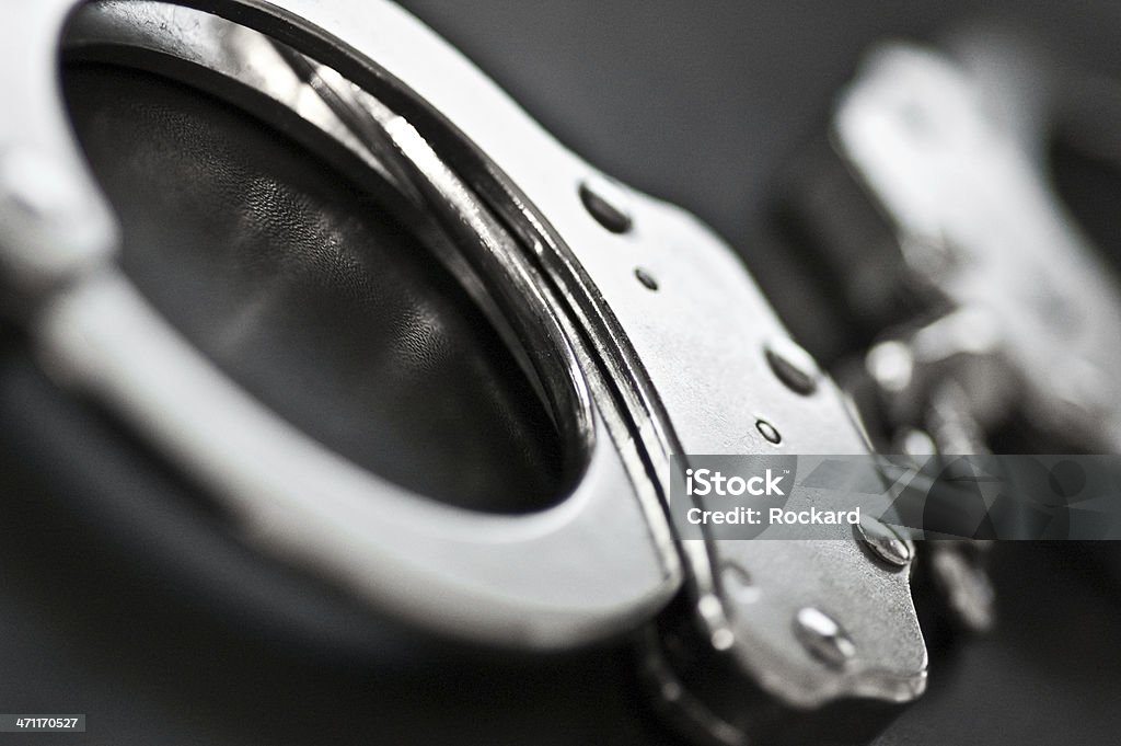 Black and white close-up of silver handcuffs closeup on handcuffs. selective focus. Handcuffs Stock Photo