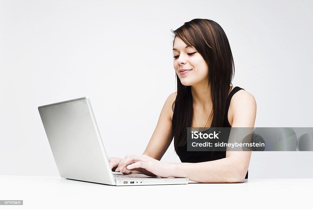 Young woman with laptop Young attractive woman using laptop on white background Laptop Stock Photo