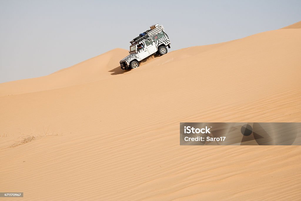 On top of the dune, Sahara Crossing huge sand dunes in the saharian desert is a big challenge for the driver. You have to take care not to loose your speed when you climb the dune otherwise you´ll  stuck in the sand. On the way down it is like a big (sand) slide... 4x4 Stock Photo