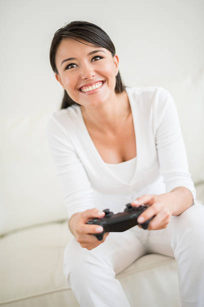 istock Woman playing a video game at home 471171432