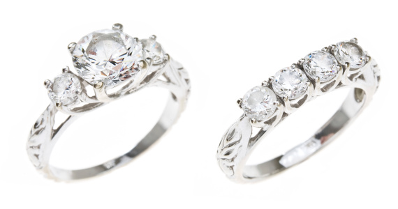 A diamond wedding set featuring a 3-stone engagement ring a 4-stone wedding band in white gold.