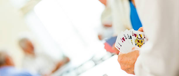 istock Panoramic shot of seniors playing cards 471171796