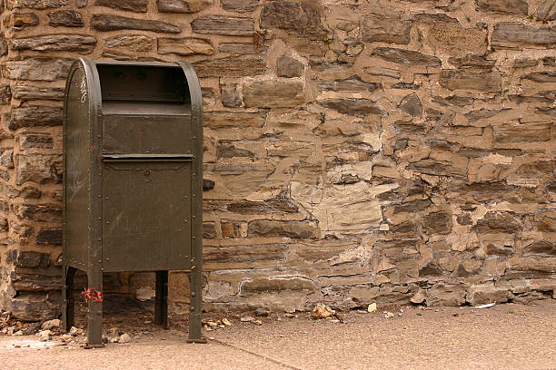 istock Mailbox in front of a cracked stone wall 471171887