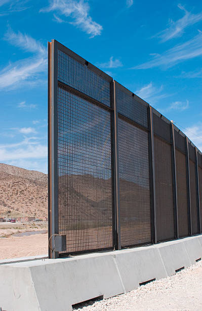 Uncompleted Border Fence. Border steel fence between El Paso, Texas, USA and Juarez, Chihuahua, Mexico. Rio Grande in photo. uncompleted stock pictures, royalty-free photos & images