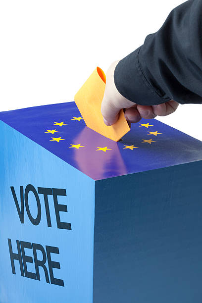 istock Male hand inserting ballot to EU ballot box 471172913