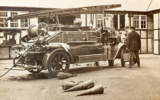 Vintage Fire Brigade Engine Vintage black and white photograph of a fire engine at the scene of an extinguished fire in wartime England. Pangbourne, UK, approx. 1940. old fire truck photos stock pictures, royalty-free photos & images