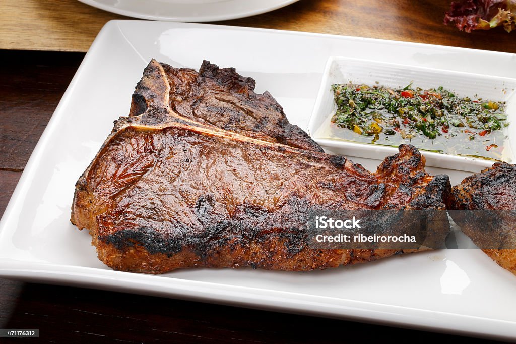 t-bone t bone steak with potato salad and vegetables T-bone Steak Stock Photo