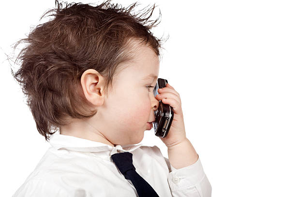 belo negócio criança usar telefone celular - telephone child isolated on white elegance - fotografias e filmes do acervo