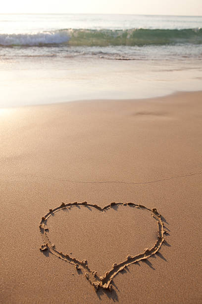 istock Hearts drawn on the sand of a beach 471176902