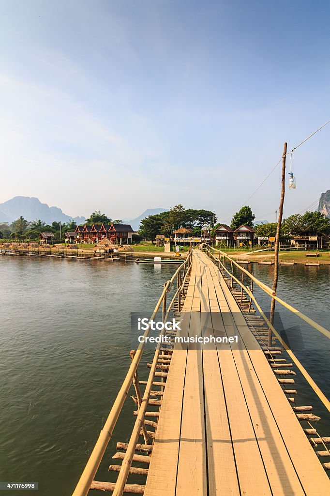 Wooden bridge over river song . Wooden bridge over river song , Vang Vieng, Laos 2015 Stock Photo