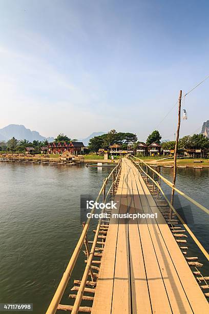 Wooden Bridge Over River Song Stock Photo - Download Image Now - 2015, Adventure, Arranging