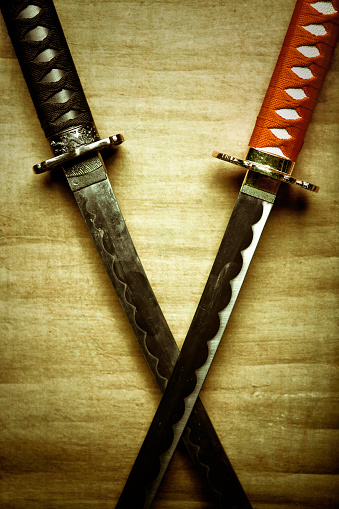 japanese swords over a wooden background surface