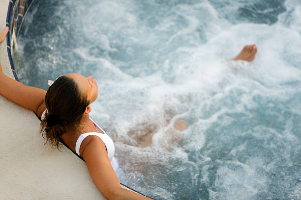 spa woman attractive woman relaxing in a whirlpool hot tub hydrotherapy stock pictures, royalty-free photos & images