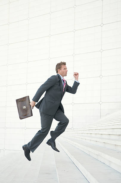 istock Businessman Running Up The White Staircase 471178429
