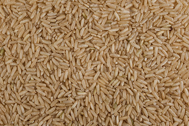 istock Unpolished brown rice texture background 471179436