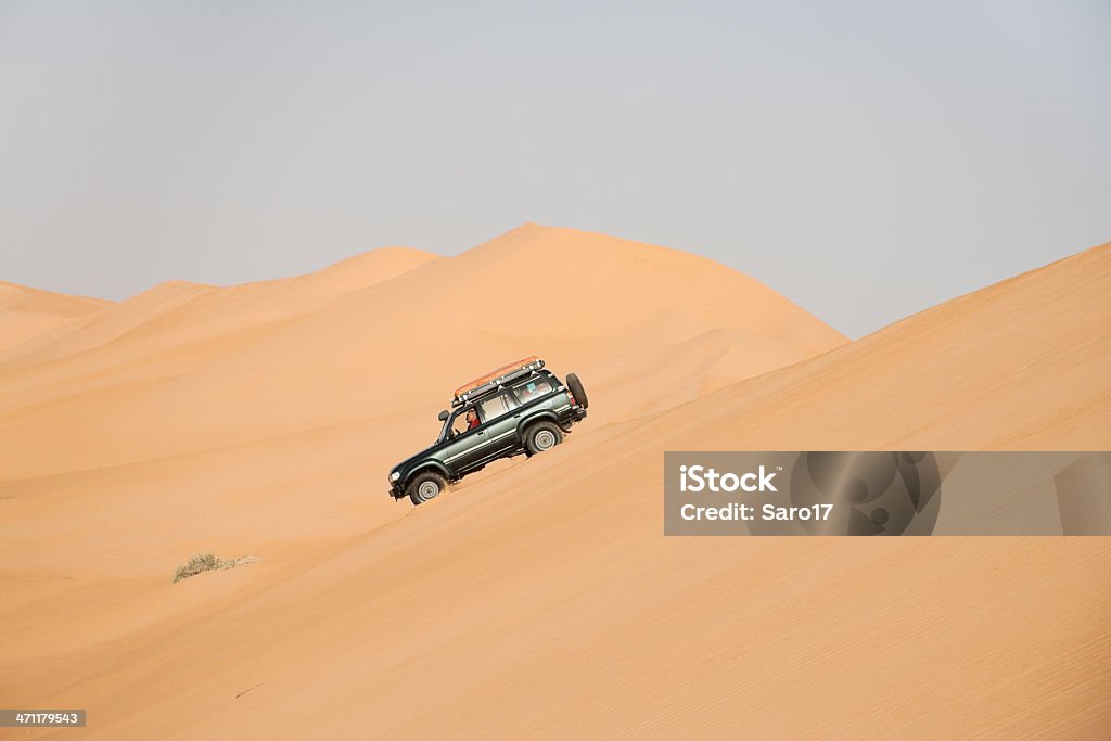 Desert driving, Sahara Experience of the drivers is one of the the main requirements to drive savely through the endless  sand areas of the saharian desert. Bush Stock Photo