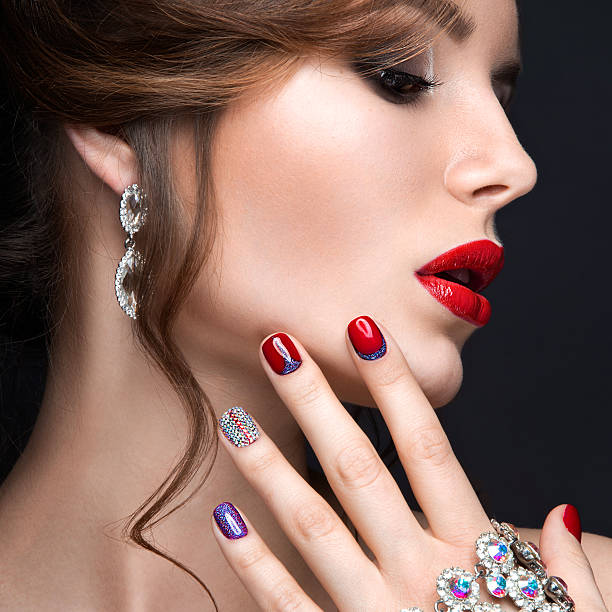 istock girl with a bright evening make-up and manicure with rhinestones. 471179666