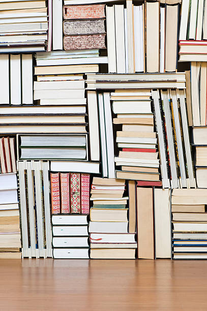 istock Large stack and rows of books on a wooden floor 471179889
