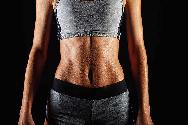 istock Close up of fit woman's torso with her hands 471180960