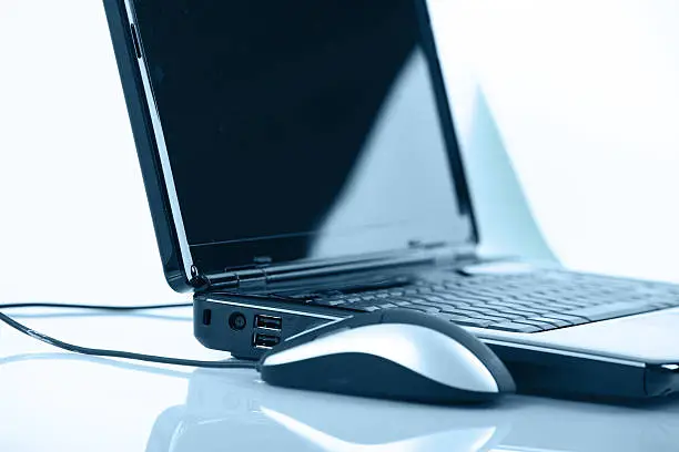 Photo of Close up of a laptop with a wired mouse