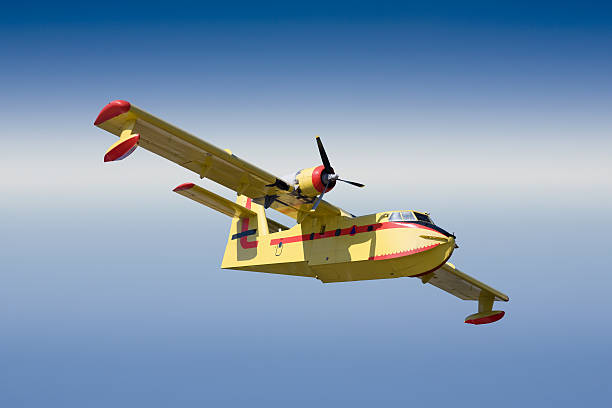 istock Blue sky over antique yellow firefighting plane 471183283