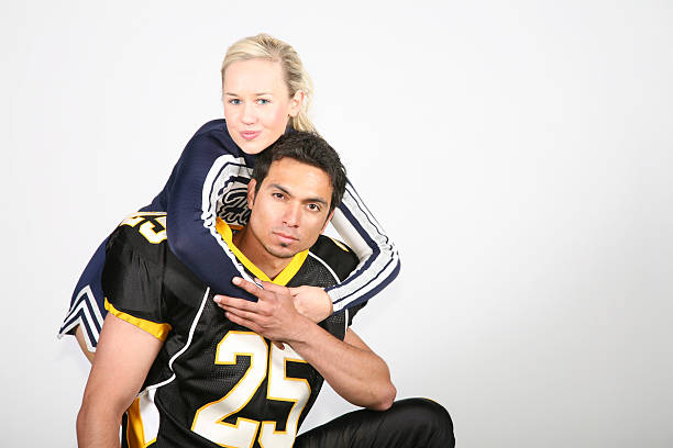 istock Cheerleader Hugging Football Player 471183421