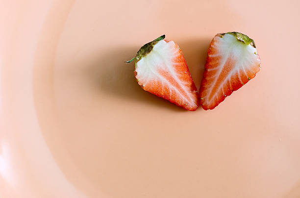 istock two pieces of cuted strawberry on plate 471183691