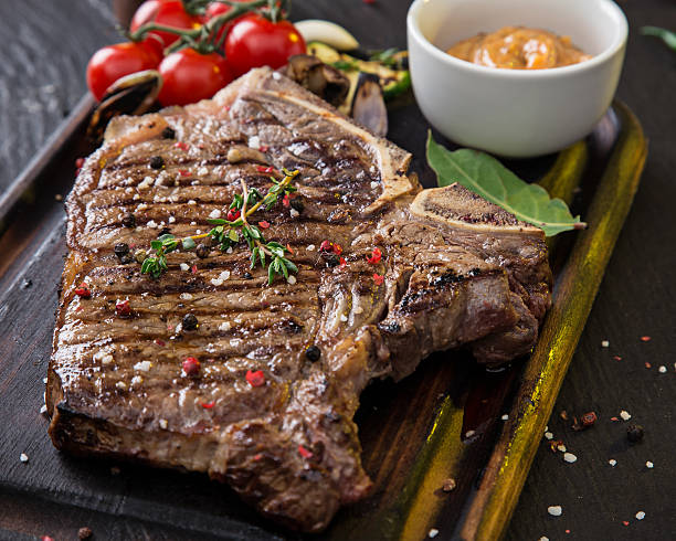 istock Beef steak on wooden table 471183846