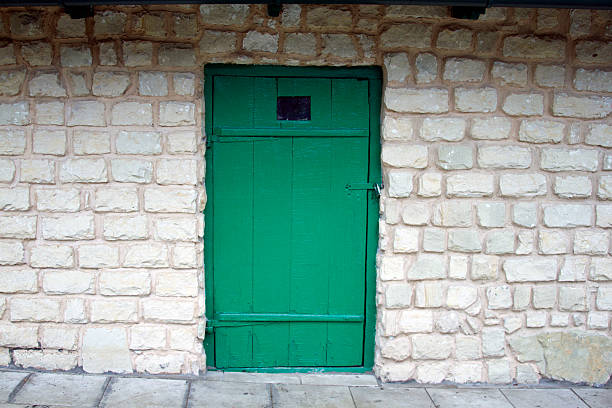 istock Old green door on the brick wall background. 471184132