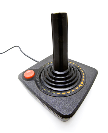 An old black and red video game joystick isolated on white with copy space.