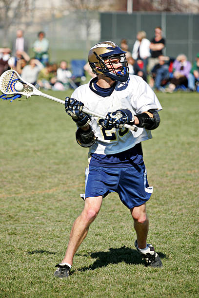 istock Attractive Male Lacrosse Player Passes or Shoots 471185031