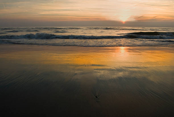 Tide movement at sunset stock photo