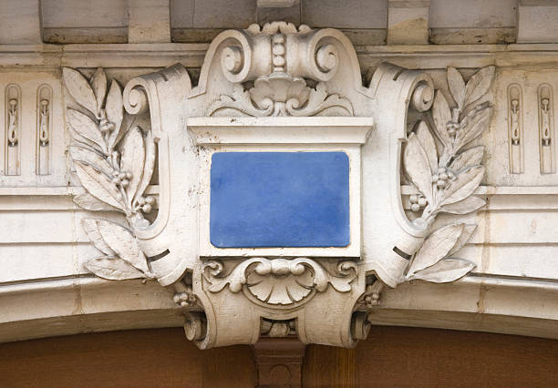 Stone Cartouche, with the ubiquitous French blue ceramic plaque, normally used for house numbering, above a Parisian doorway.