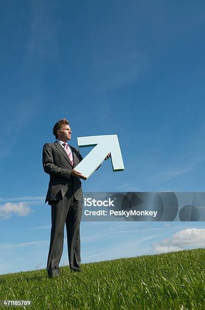 Businessman Holding Big Arrow Pointing Up Blue Sky Green Meadow Stock Photo - Download Image Now