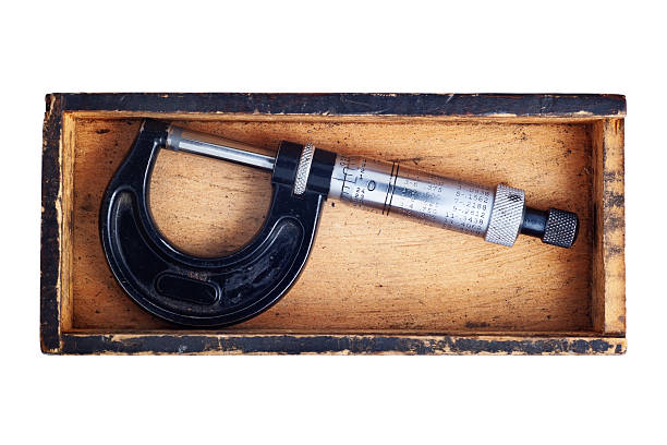 Micrometer In Box Caliper Micrometer (caliper) in a wooden box.http://www.stock.pointco.org/lightbox-measuring.jpg micrometer screw gauge stock pictures, royalty-free photos & images