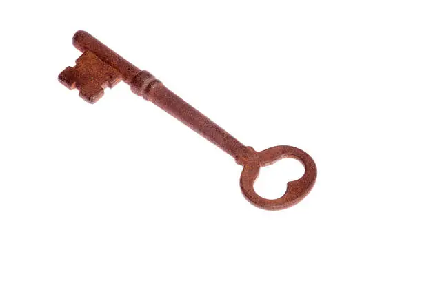 One antique rusty key on isolated white background.