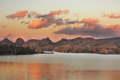 Southwest desert sunset alpenglow above lake and surrounding granite terrain with ducks in foreground.  Watson Lake, Granite Dells, 2009.